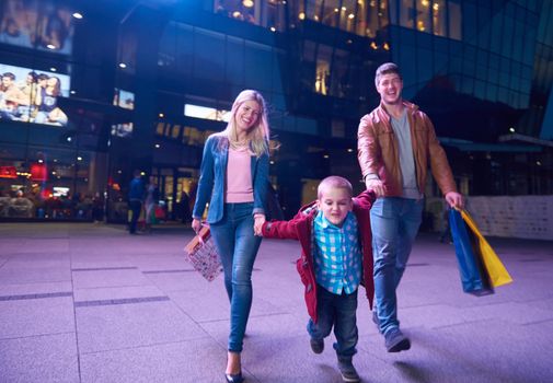 Group Of Friends Enjoying Shopping Trip Together
group of happy young frineds enjoying shopping night and walking on steet on night in with mall in background