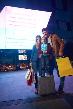 Group Of Friends Enjoying Shopping Trip Together
group of happy young frineds enjoying shopping night and walking on steet on night in with mall in background