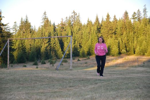 young woman working out in nature