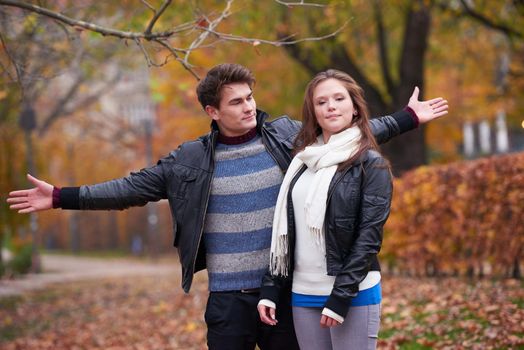 romantic young couple have fun in city park at autumn season