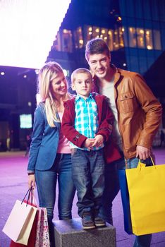 Group Of Friends Enjoying Shopping Trip Together
group of happy young frineds enjoying shopping night and walking on steet on night in with mall in background