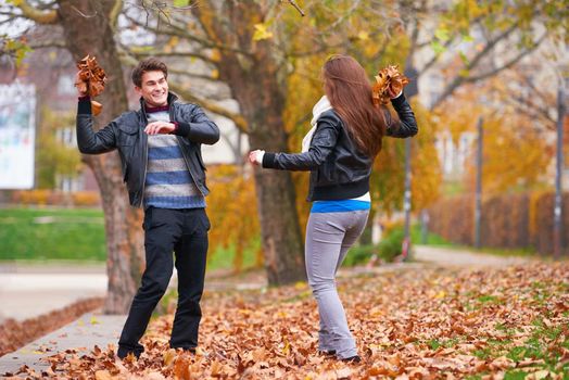 romantic young couple have fun in city park at autumn season