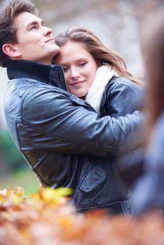 romantic young couple have fun in city park at autumn season