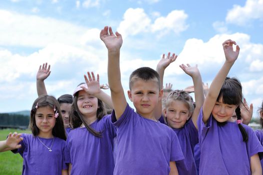 happy kids group have fun in nature outdoors park