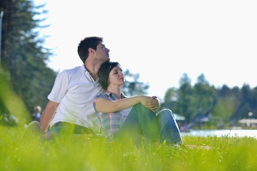 Portrait of romantic young couple in love  smiling together outdoor in nature with blue sky in background