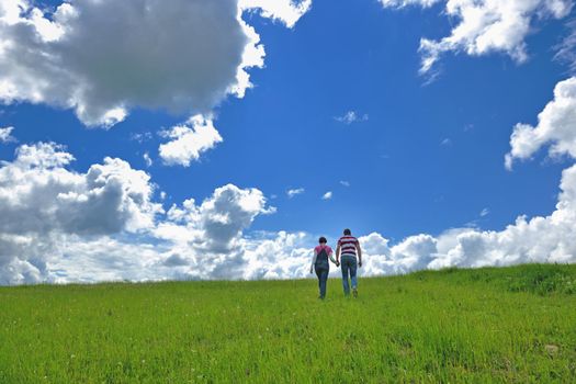 Portrait of romantic young couple in love  smiling together outdoor in nature with blue sky in background