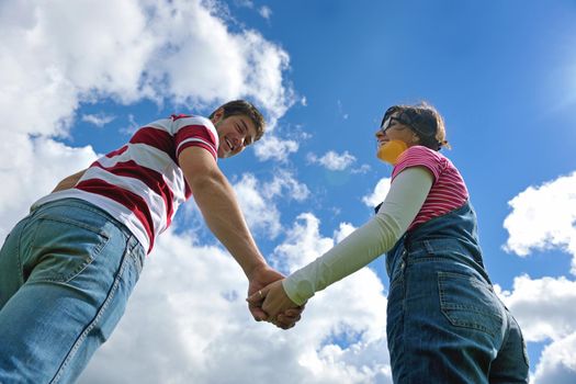 Portrait of romantic young couple in love  smiling together outdoor in nature with blue sky in background