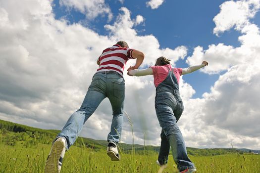 Portrait of romantic young couple in love  smiling together outdoor in nature with blue sky in background