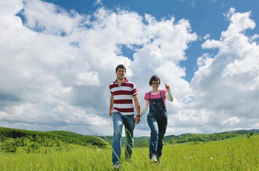 Portrait of romantic young couple in love  smiling together outdoor in nature with blue sky in background