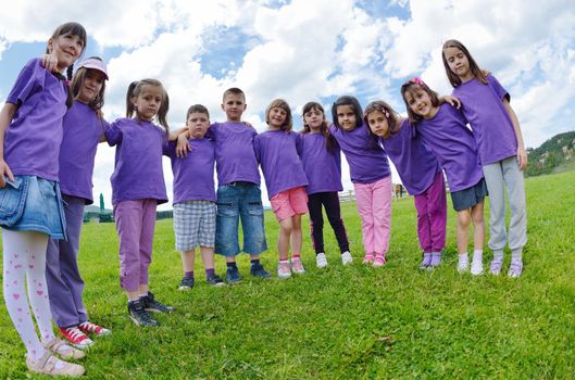 happy kids group have fun in nature outdoors park