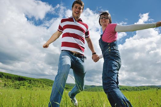 Portrait of romantic young couple in love  smiling together outdoor in nature with blue sky in background