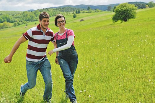 Portrait of romantic young couple in love  smiling together outdoor in nature with blue sky in background