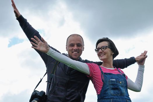 Portrait of romantic young couple in love  smiling together outdoor in nature with blue sky in background