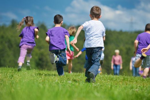 happy kids group have fun in nature outdoors park