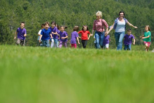 happy kids group have fun in nature outdoors park