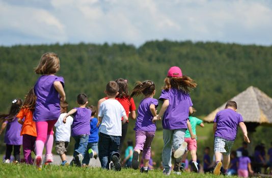 happy kids group have fun in nature outdoors park