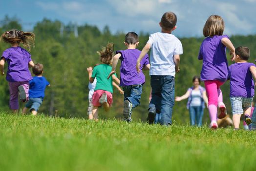 happy kids group have fun in nature outdoors park