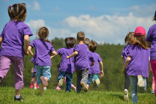 happy kids group have fun in nature outdoors park