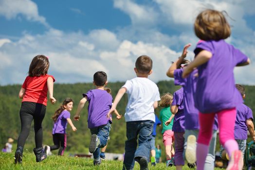 happy kids group have fun in nature outdoors park