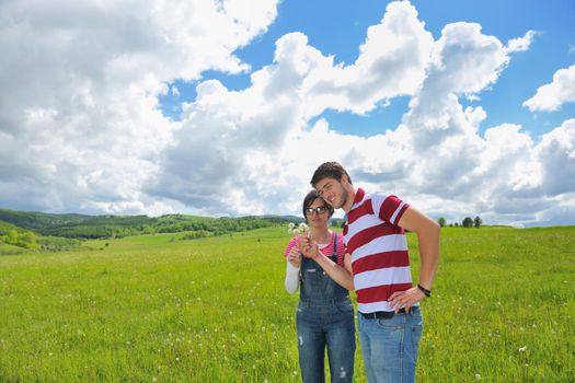 Portrait of romantic young couple in love  smiling together outdoor in nature with blue sky in background