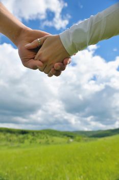 Portrait of romantic young couple in love  smiling together outdoor in nature with blue sky in background