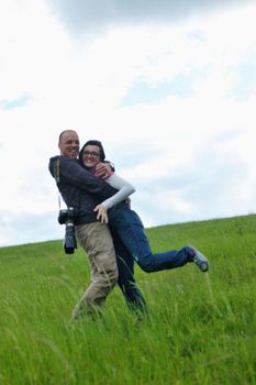 Portrait of romantic young couple in love  smiling together outdoor in nature with blue sky in background