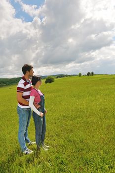 Portrait of romantic young couple in love  smiling together outdoor in nature with blue sky in background