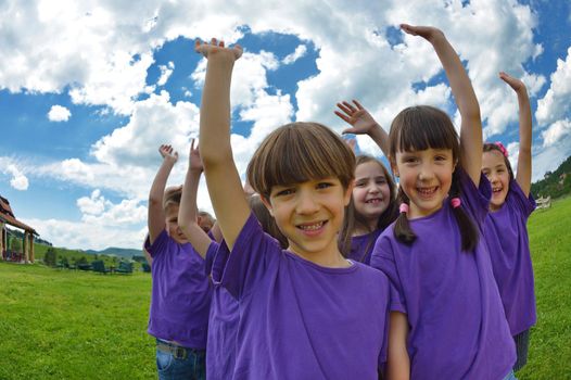 happy kids group have fun in nature outdoors park