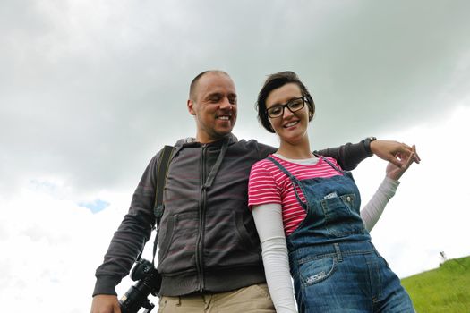 Portrait of romantic young couple in love  smiling together outdoor in nature with blue sky in background