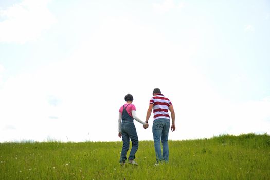 Portrait of romantic young couple in love  smiling together outdoor in nature with blue sky in background