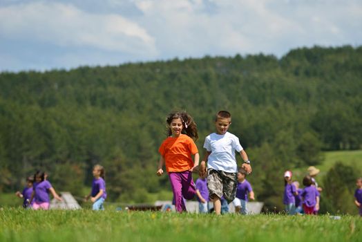 happy kids group have fun in nature outdoors park