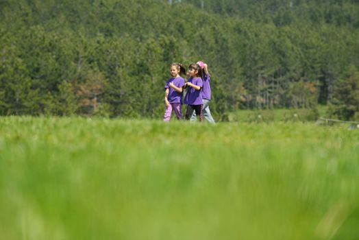 happy kids group have fun in nature outdoors park