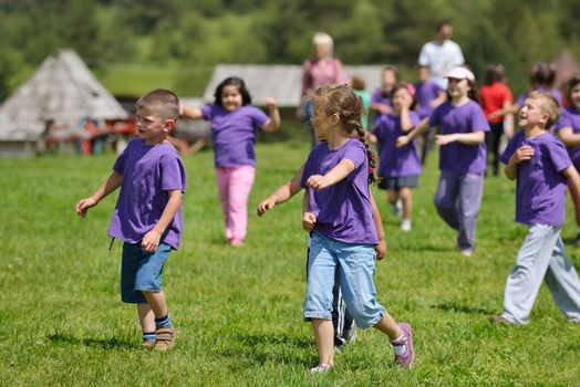 happy kids group have fun in nature outdoors park