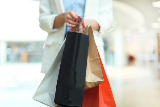 woman hand hold shopping bag at clothes store.