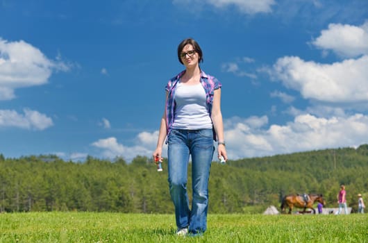 Enjoying the nature and life. Young woman arms raised enjoying the fresh air in green nature