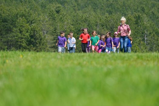 happy kids group have fun in nature outdoors park