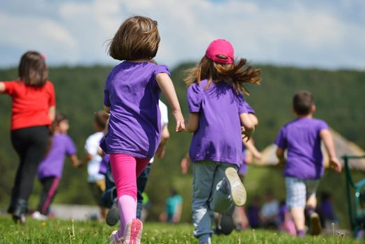 happy kids group have fun in nature outdoors park