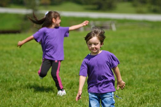 happy kids group have fun in nature outdoors park