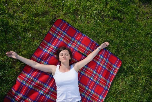 Enjoying the nature and life. Young woman arms raised enjoying the fresh air in green nature