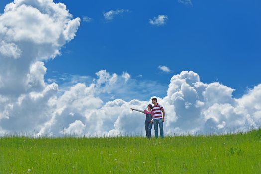 Portrait of romantic young couple in love  smiling together outdoor in nature with blue sky in background