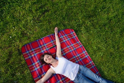 Enjoying the nature and life. Young woman arms raised enjoying the fresh air in green nature