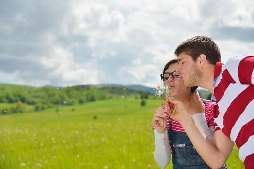 Portrait of romantic young couple in love  smiling together outdoor in nature with blue sky in background