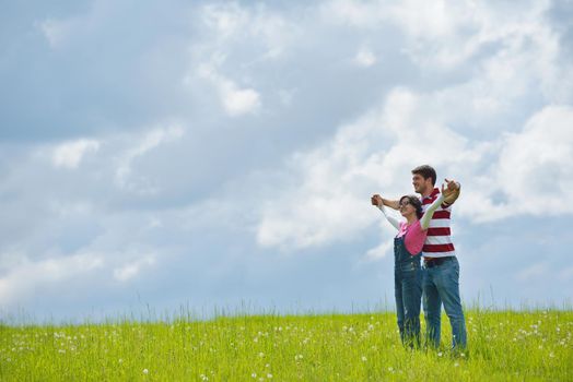 Portrait of romantic young couple in love  smiling together outdoor in nature with blue sky in background