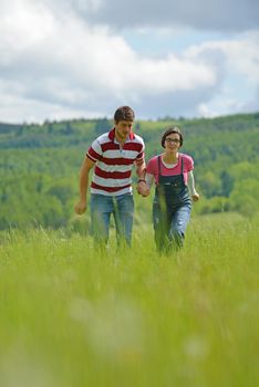 Portrait of romantic young couple in love  smiling together outdoor in nature with blue sky in background