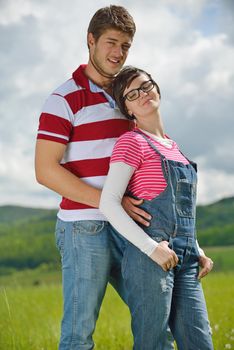 Portrait of romantic young couple in love  smiling together outdoor in nature with blue sky in background