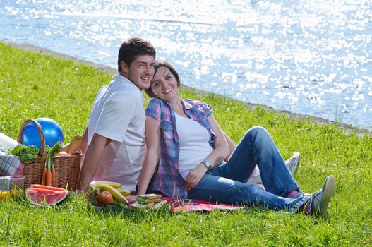 happy young romantic couple in love   having a picnic outdoor on a summer day