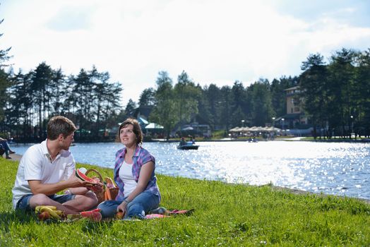 happy young romantic couple in love   having a picnic outdoor on a summer day