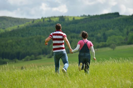 Portrait of romantic young couple in love  smiling together outdoor in nature with blue sky in background