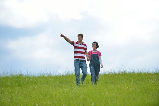 Portrait of romantic young couple in love  smiling together outdoor in nature with blue sky in background