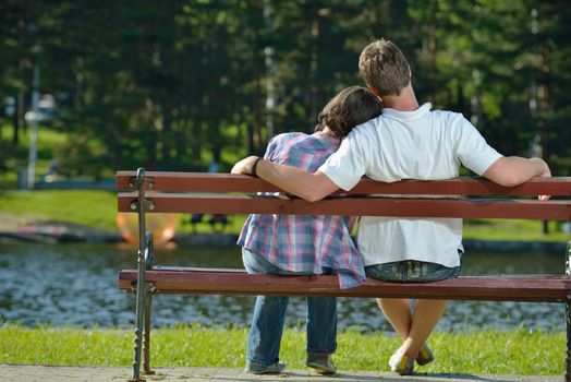 Portrait of romantic young couple in love  smiling together outdoor in nature with blue sky in background